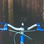 How do brake cables work, and how to adjust them. Front view of a set of bike brake levers and brake cables on a blue and silver bike.